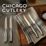  Insignia Steel 4-piece Steak Knife Set on table sitting on napkin